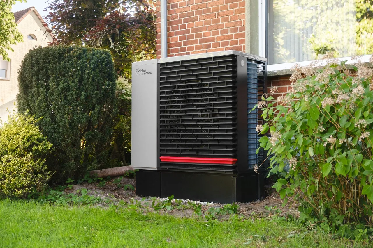 Outdoor heat pump unit beside a home